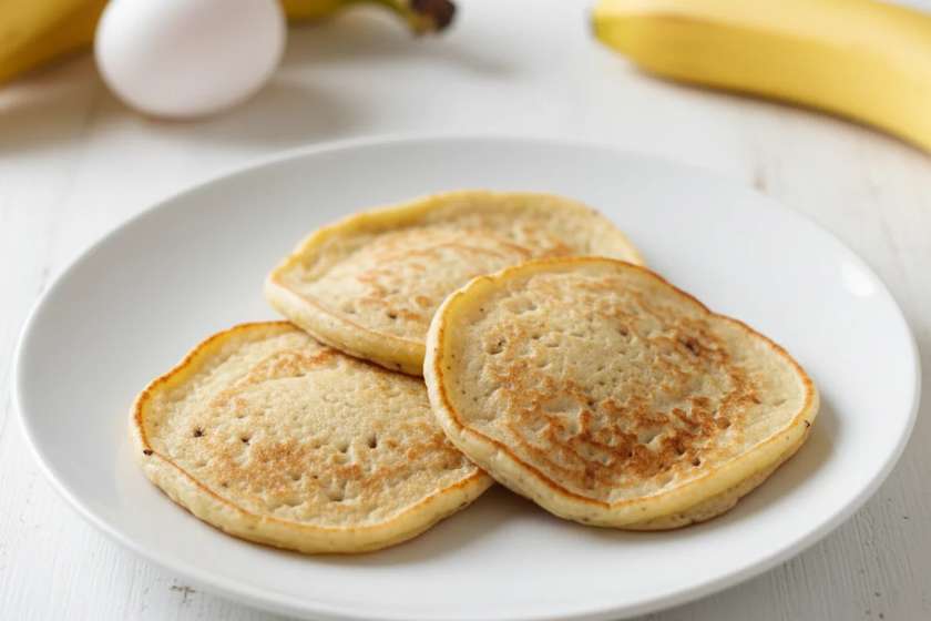 Two-ingredient banana pancakes made with only eggs and bananas on white plate