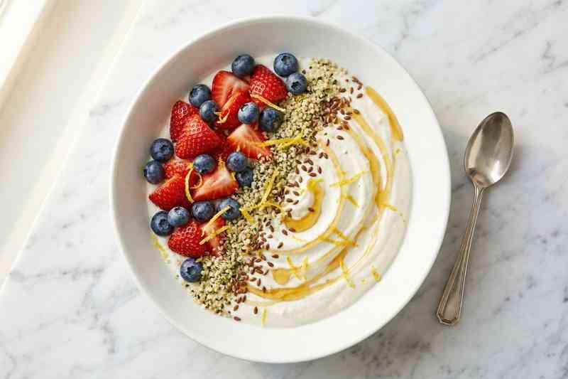 High protein low calorie meal cottage cheese bowl with fresh berries and honey