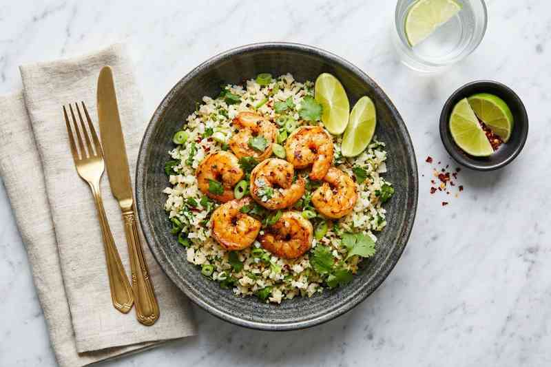 High protein low calorie meal shrimp and cauliflower rice bowl with cilantro