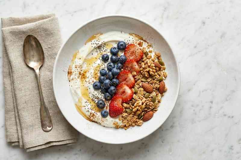 Greek yogurt high protein bowl with fresh berries honey and granola