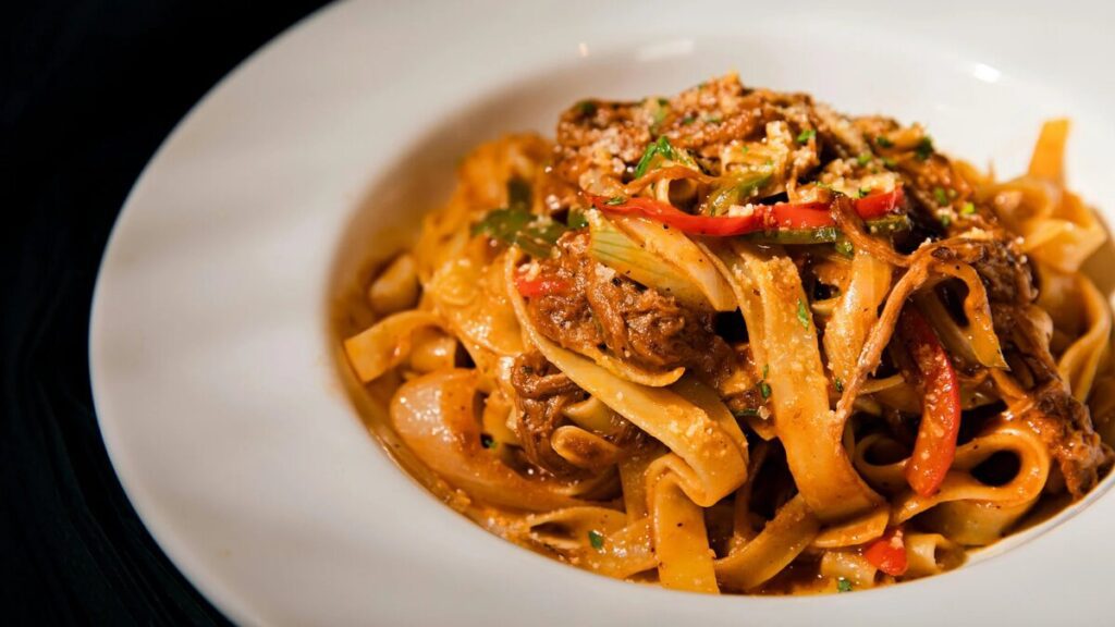 Colorful vegan Buddha bowl with quinoa, roasted vegetables, avocado, boiled eggs, broccoli, and sesame seeds on a bright plate