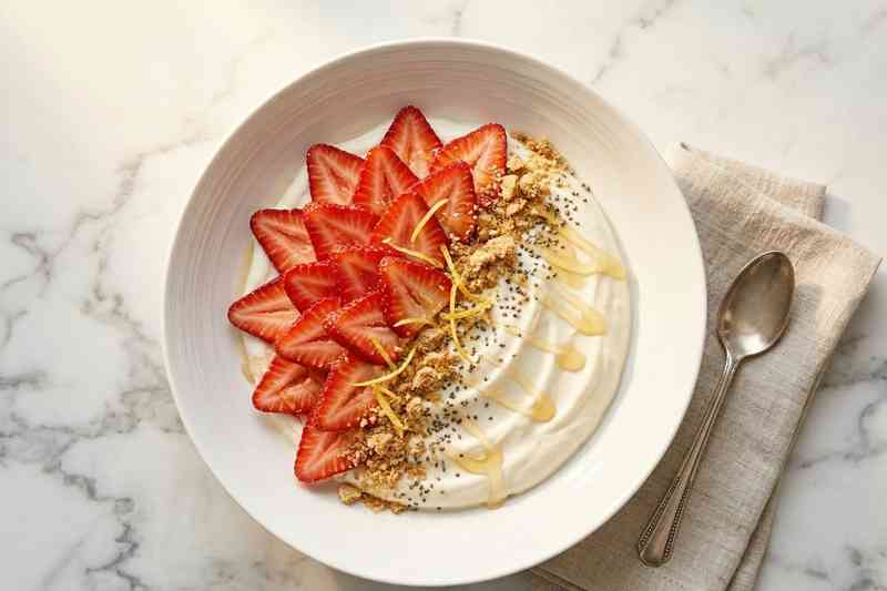Greek yogurt high protein bowl with strawberries graham cracker and honey
