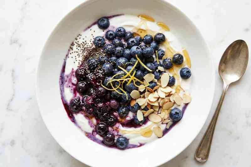 Greek yogurt high protein bowl with blueberries lemon zest and chia seeds