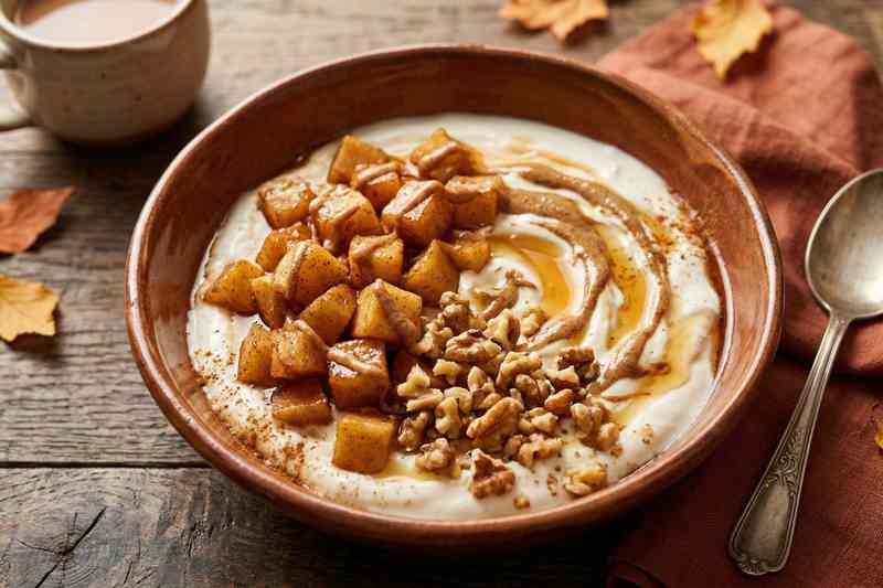 Greek yogurt high protein bowl with cinnamon apple walnuts and maple syrup