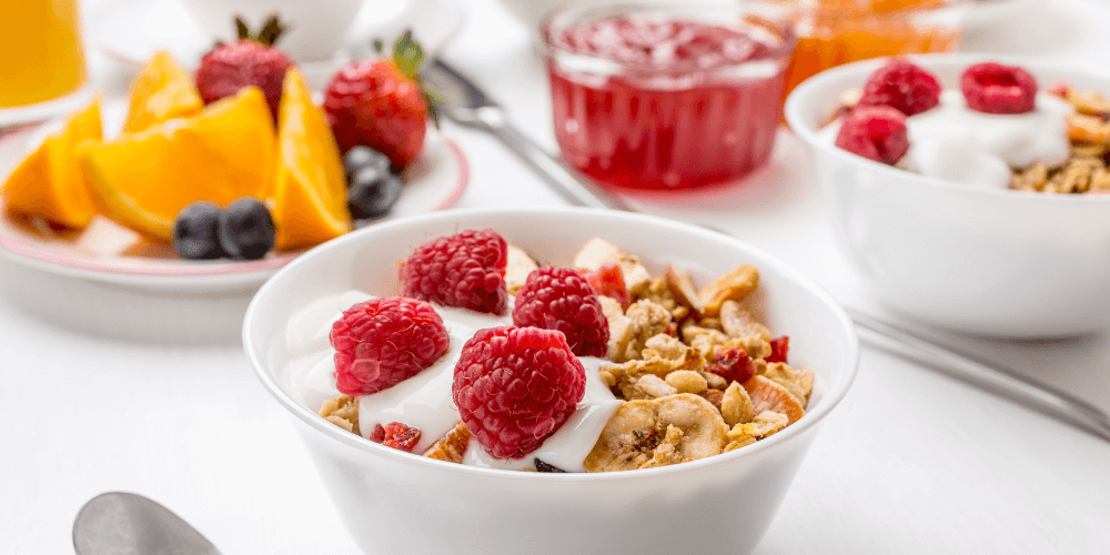 Healthy breakfast plate with a variety of fruits and granola, perfect for a nutritious morning meal.