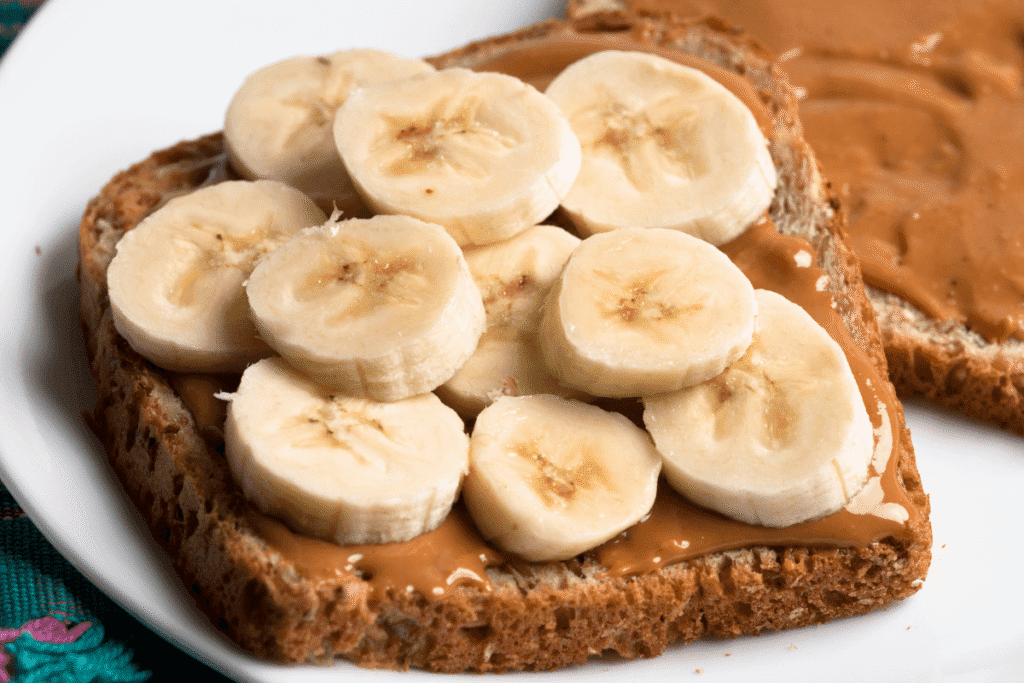 Whole grain toast topped with natural peanut butter and sliced bananas – a simple high-protein breakfast idea