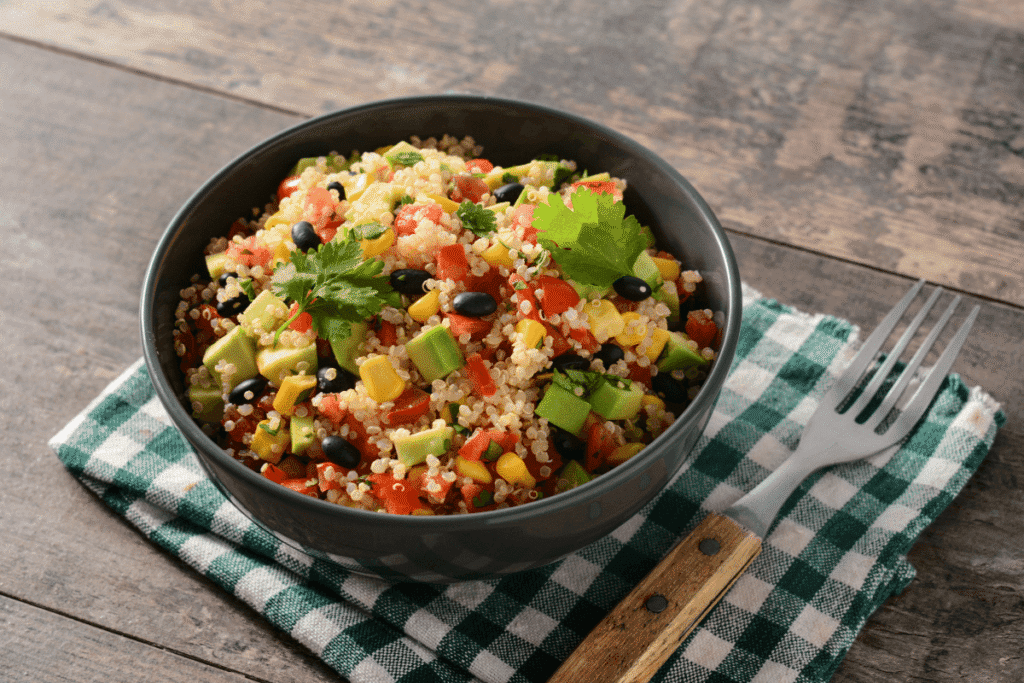 Healthy quinoa salad bowl with fresh vegetables and herbs – perfect for a light lunch or meal prep. High-protein, vegan, and gluten-free.