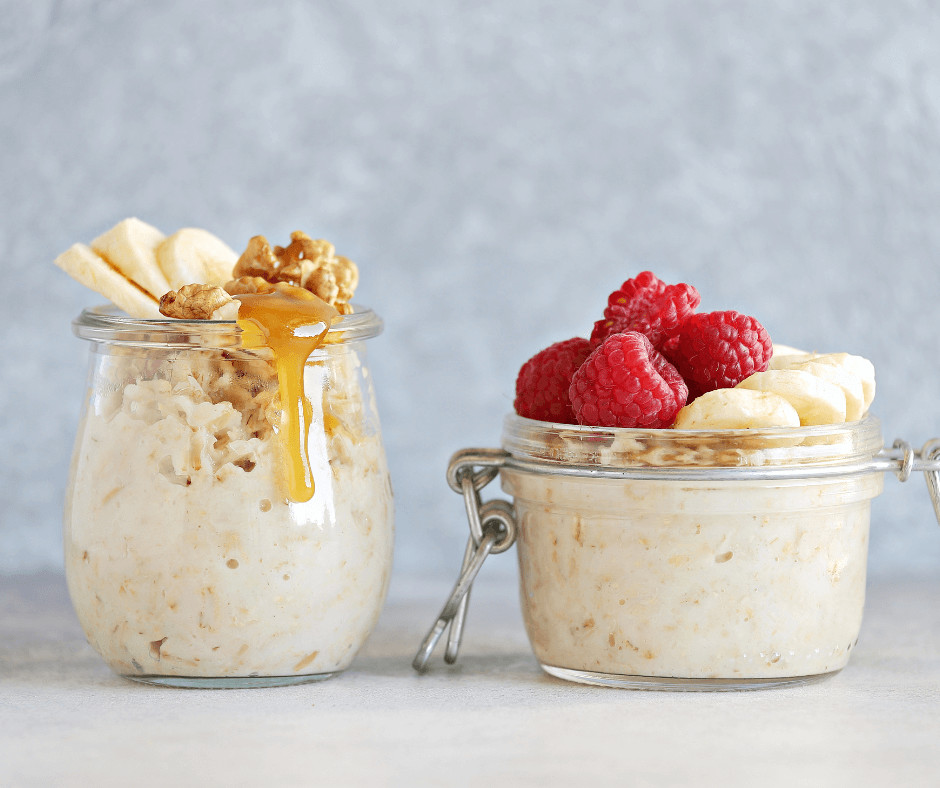 Healthy overnight oats in jars topped with raspberries, almonds, and drizzled peanut butter – easy meal prep breakfast