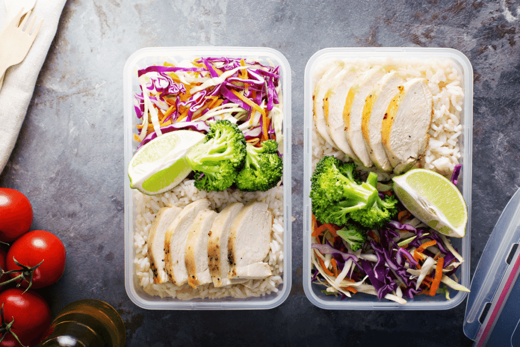 Chicken breast meal prep bowls with brown rice, broccoli, shredded cabbage, and lime – healthy high-protein lunch containers High-Protein Meal Prep