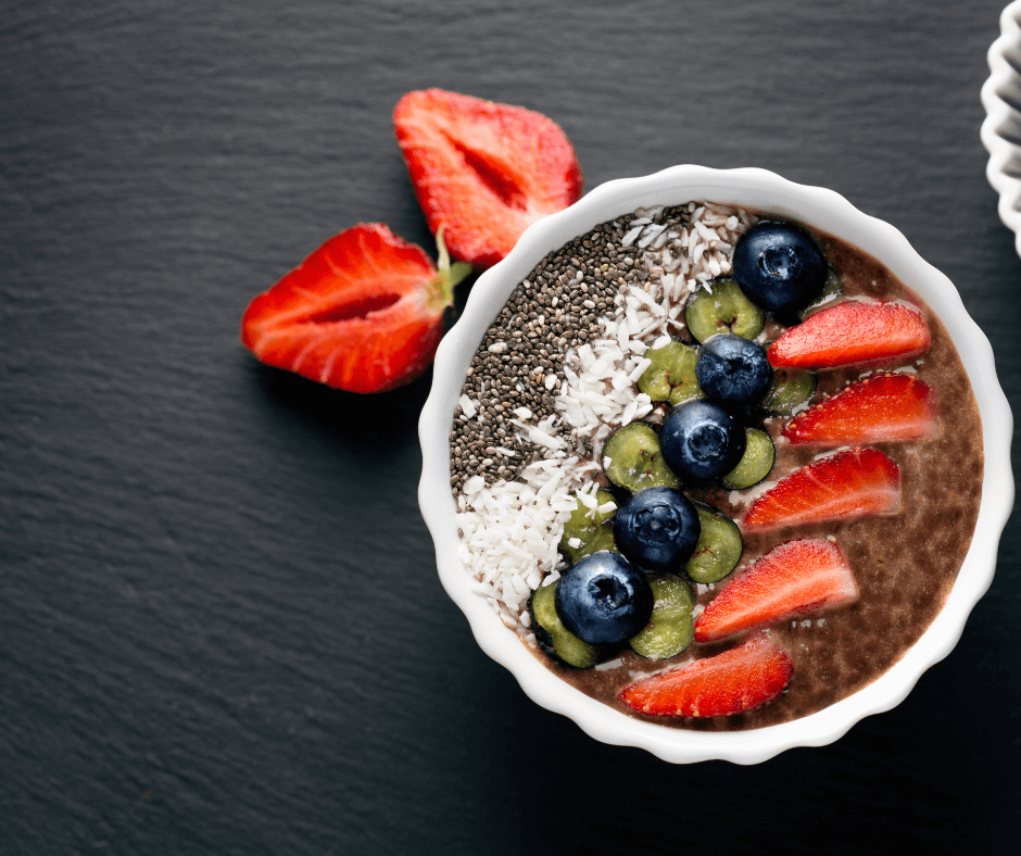 High-protein chia pudding topped with strawberries, blueberries, kiwi, and shredded coconut.