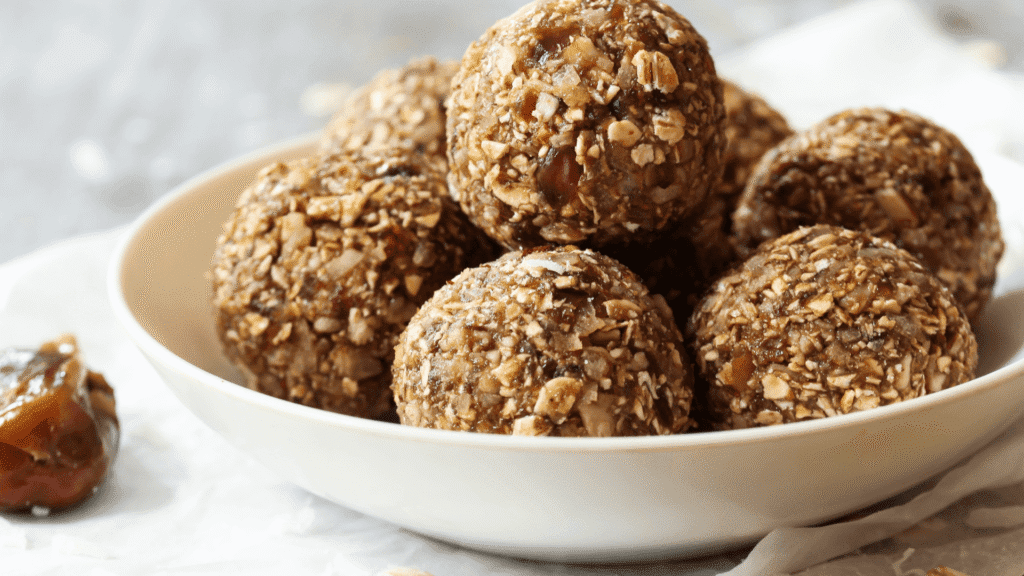 Homemade Chocolate Peanut Butter Protein Balls stacked in a white bowl – healthy low calorie high protein snack