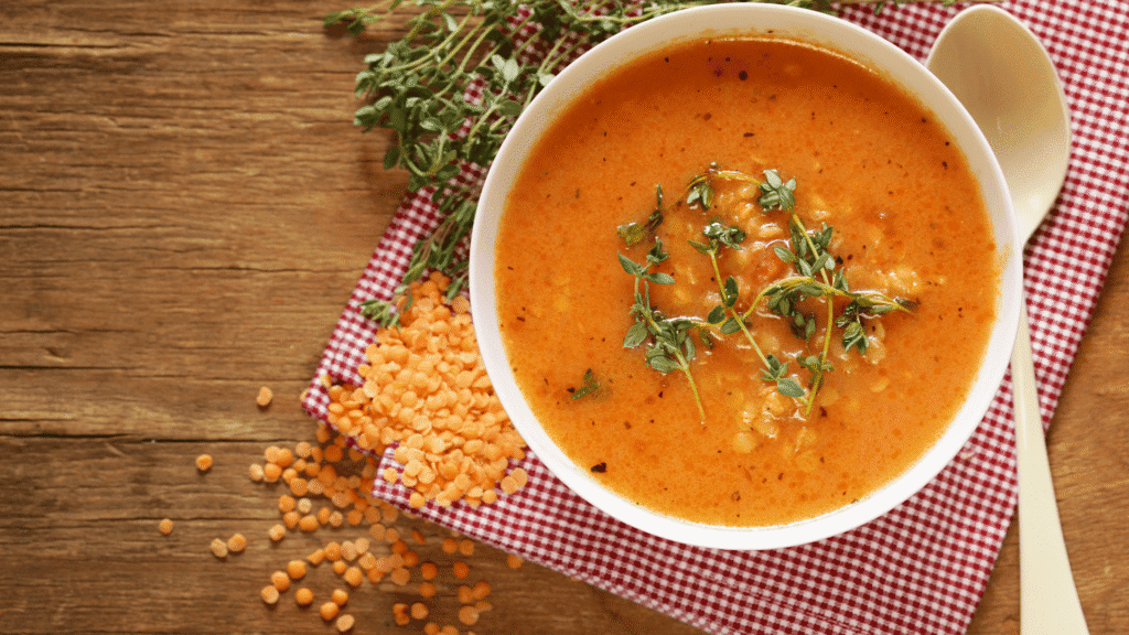 Tomato Basil Soup with White Beans in a bowl on rustic wood background – healthy high protein low calorie recipe