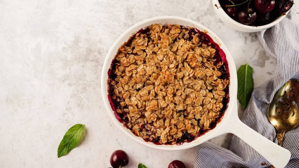 Top view of healthy cherry baked oats with crispy oat topping – easy high-protein breakfast idea