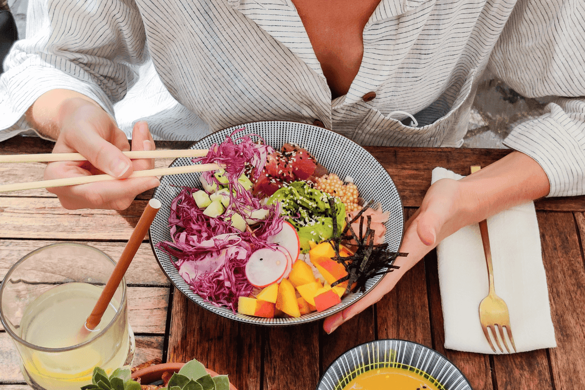 Cheap healthy poke bowl with fresh vegetables, mango, avocado, and tuna