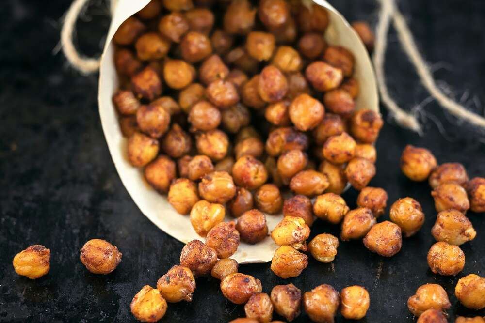 Roasted spiced chickpeas in a wooden bowl, high protein plant based snack