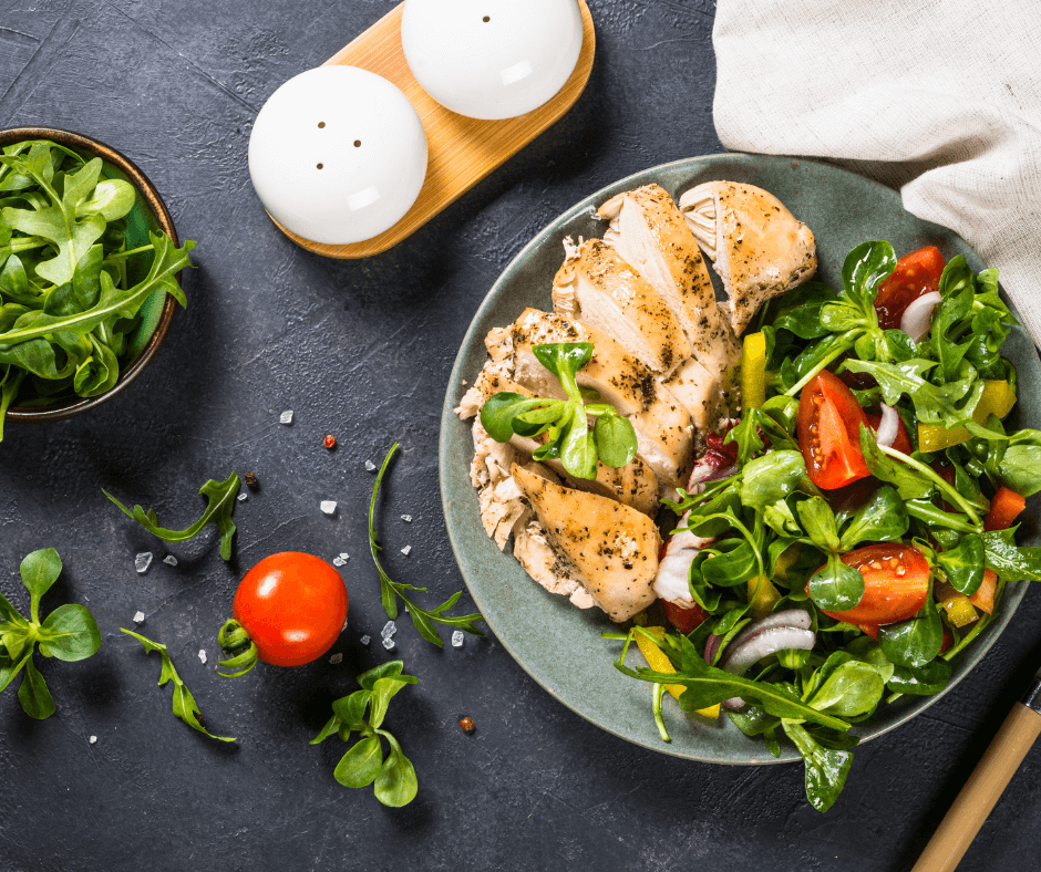 "Cheap healthy grilled chicken salad with fresh spinach, cherry tomatoes, and avocado