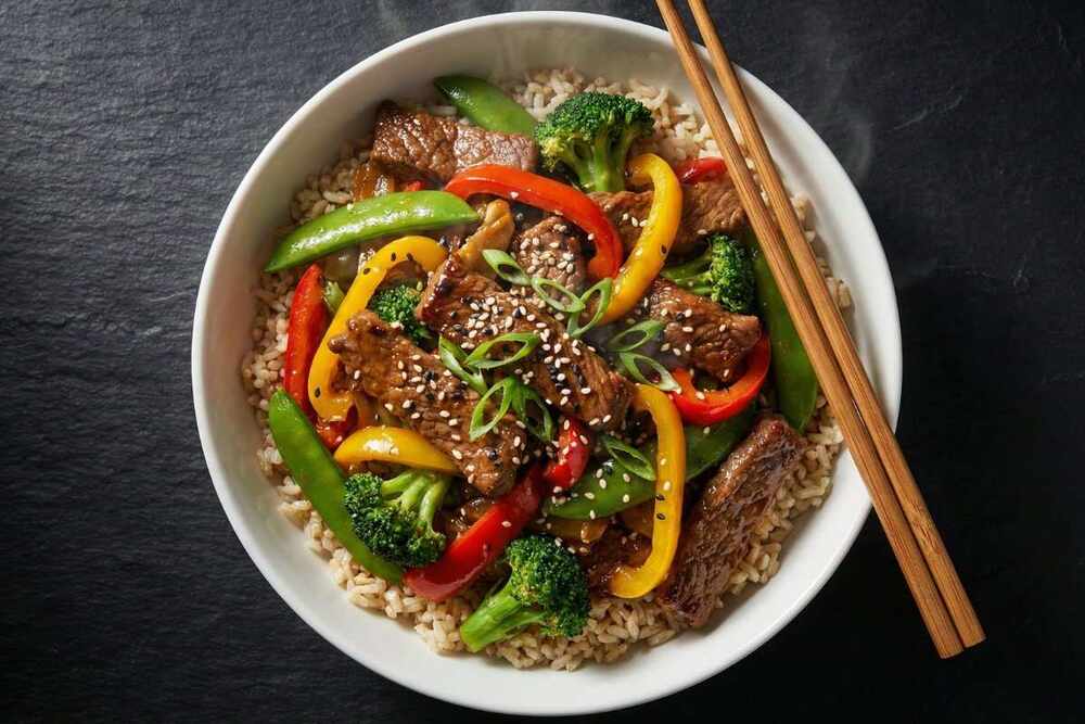 High protein beef stir fry with vegetables over brown rice