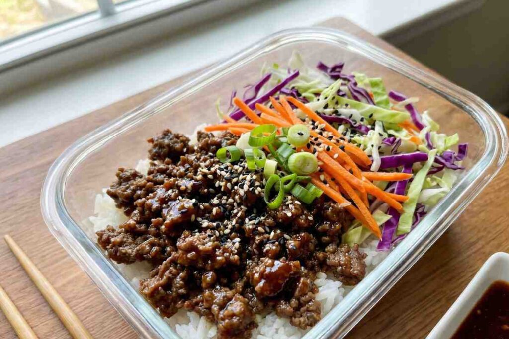 korean beef bowl meal prep with cabbage carrots rice and sesame seeds