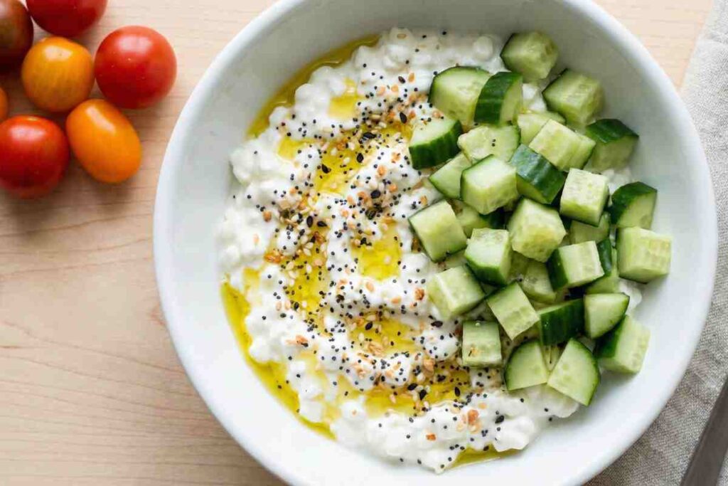 Cottage cheese bowl topped with cucumber, everything seasoning, and olive oil - viral high protein snack with 26g protein