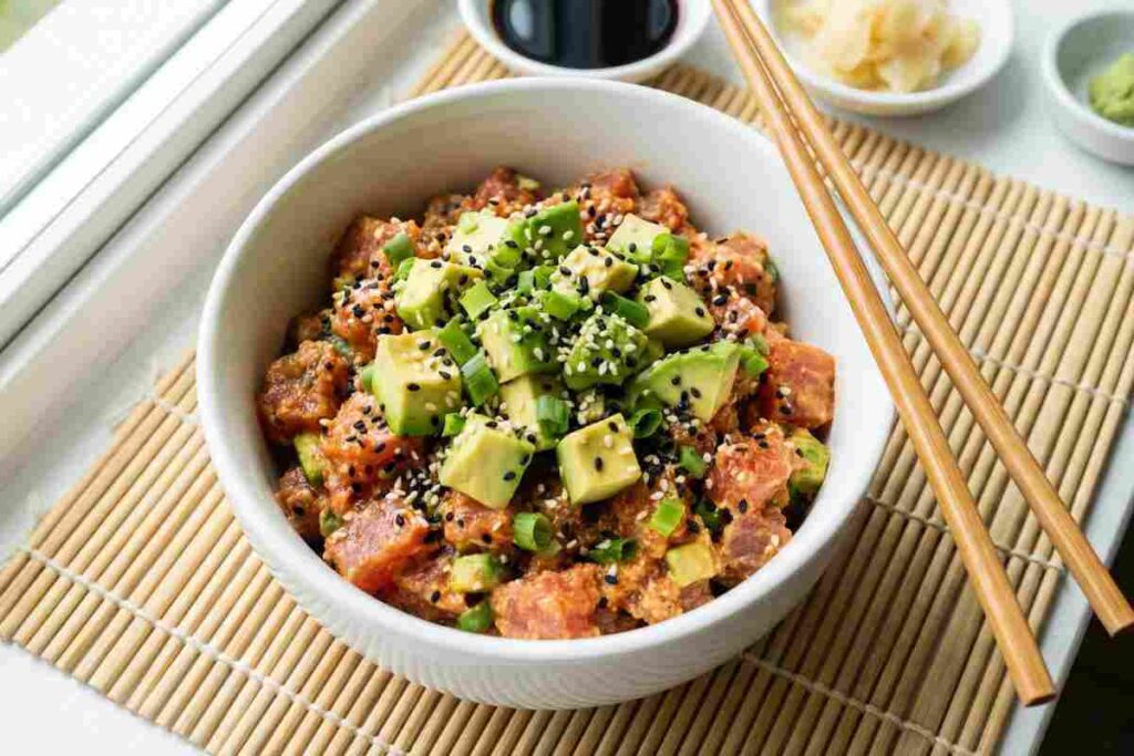 Spicy tuna avocado bowl with sesame seeds and green onions - sushi-inspired high protein snack with 25g protein