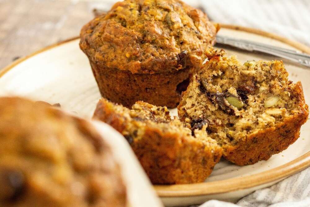 Pumpkin spice protein muffins meal prep with walnuts on white plate