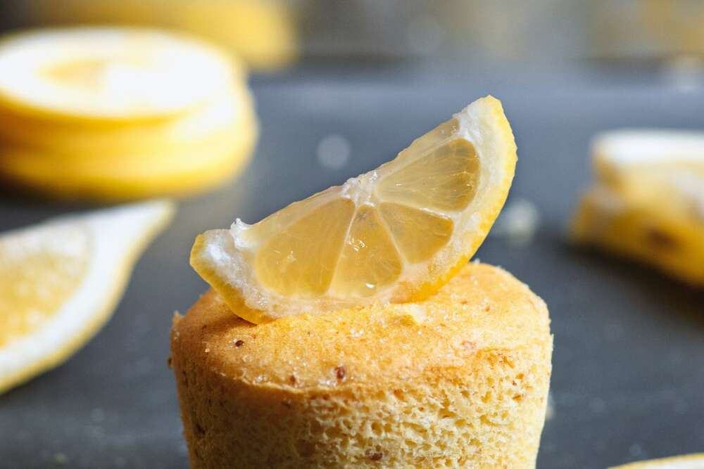 Lemon poppy seed protein muffins meal prep with fresh lemon slices